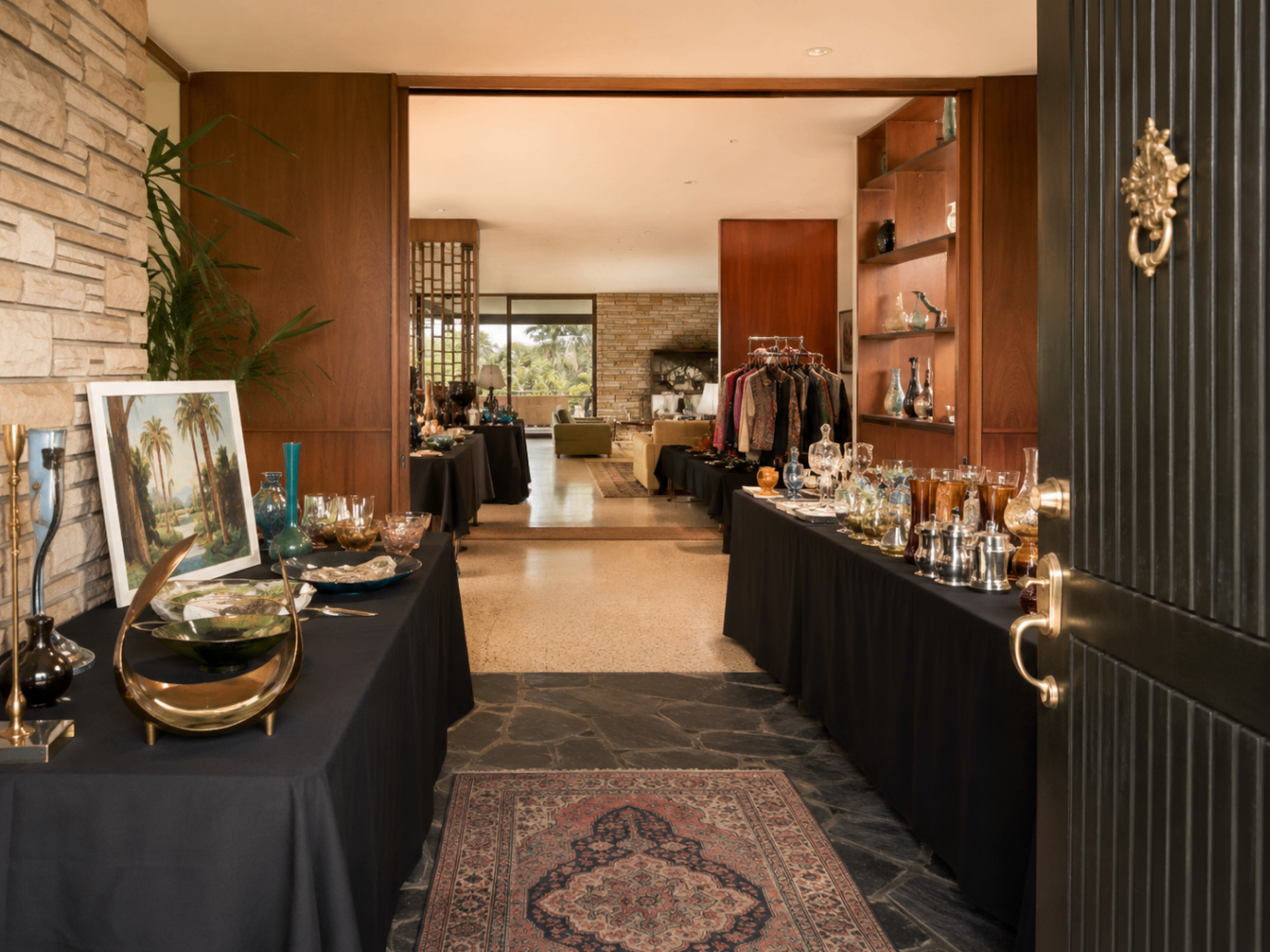 Hollywood estate sale setup with vintage guitars, signed posters, and mid-century furniture — Triumphant Estate Sales Los Angeles